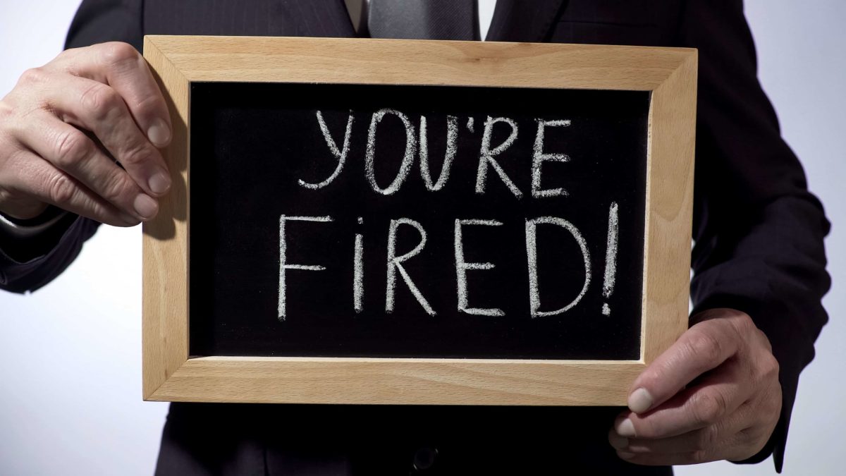 businessman holding chalk board with the words 'you're fired' on it representing rio ceo