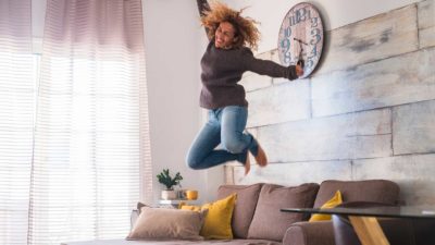 surging asx ecommerce share price represented by woman jumping off sofa in excitement