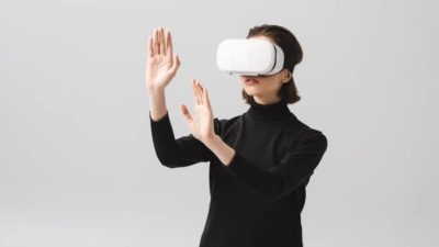 asking where Facebook shares will be in 5 years represented by woman wearing virtual reality googles and placing hands in front of her
