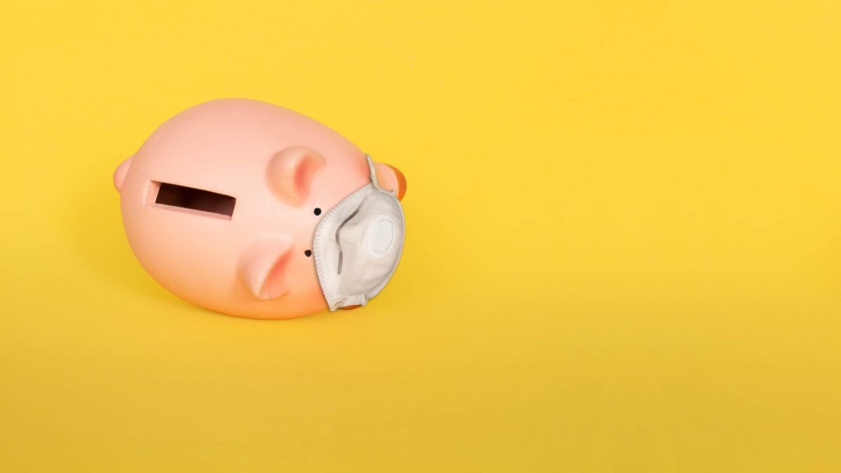 falling asx share price represented by piggy bank wearing doctor's mask having fallen over