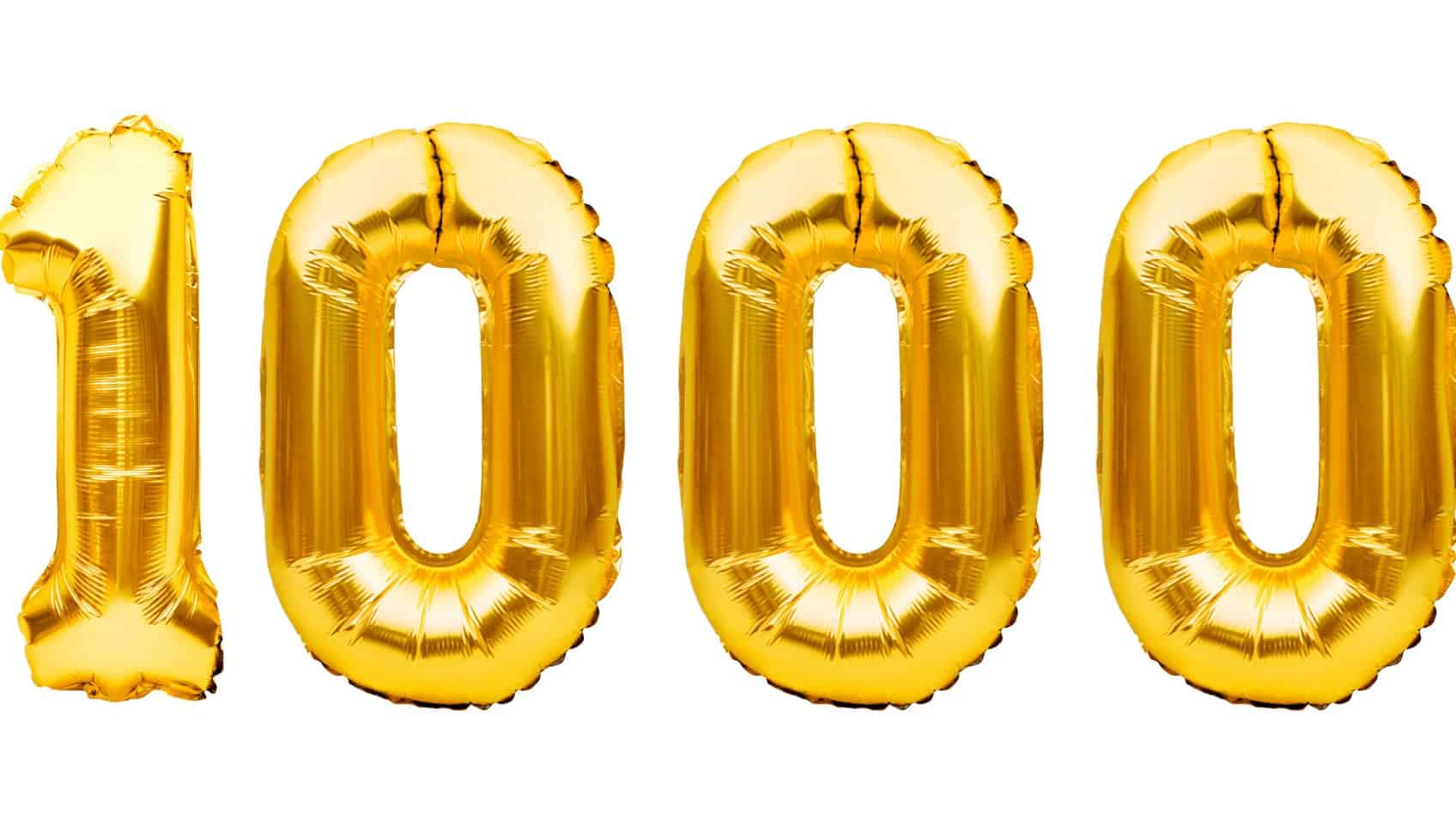 success of nearmap share price represented by gold baloons spelling out one thousand