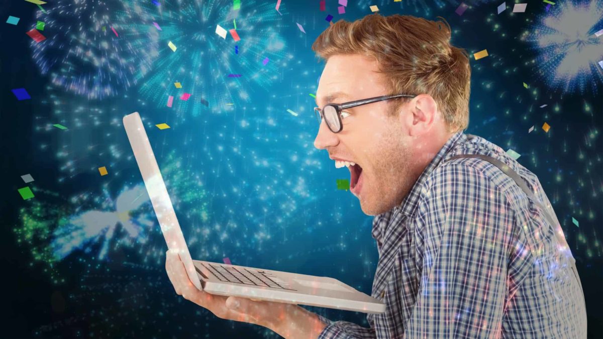 Man looking excitedly at ASX share price gains on computer screen against backdrop of streamers