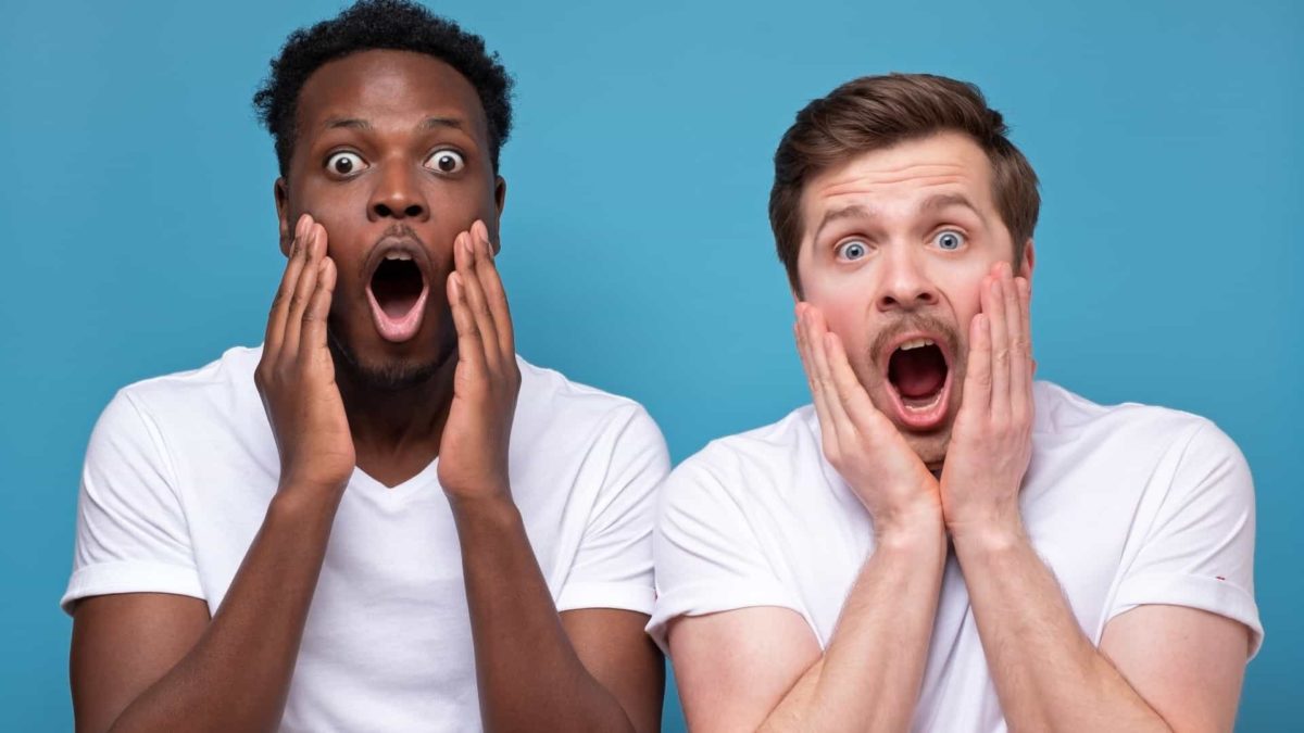 Two men react in shock at Evolution share price drop record profit