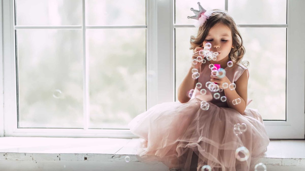 Little girl blowing bubbles illustrating don't sweat the small stuff.