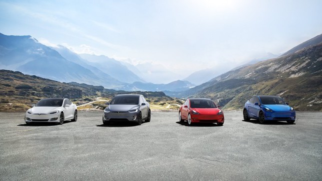 Tesla stock represented by four tesla electric vehicles parked against mountain backdrop