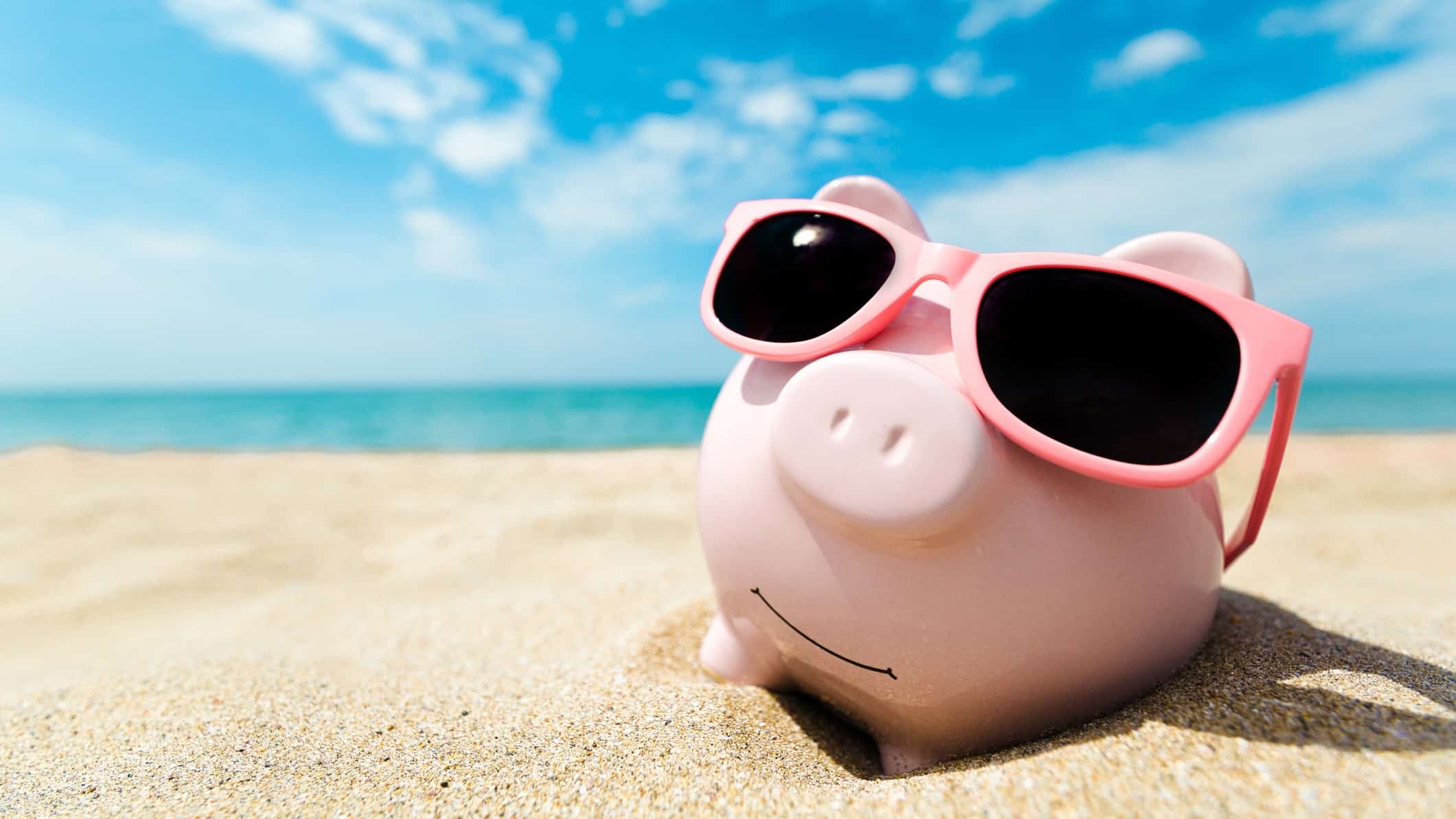 top asx shares to buy in summer or to retire represented by piggy bank on sunny beach