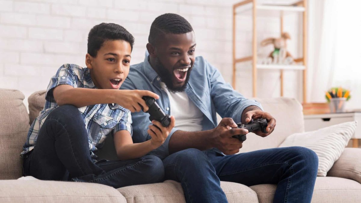 Cheerful Father And Son Competing In Video Games At Home