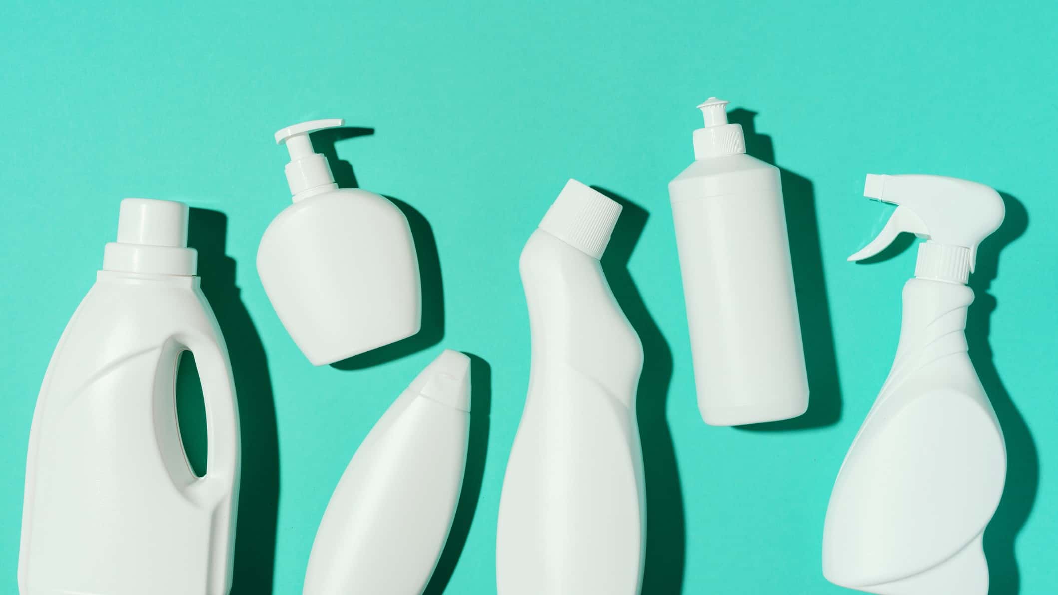 White plastic bottles on aqua background