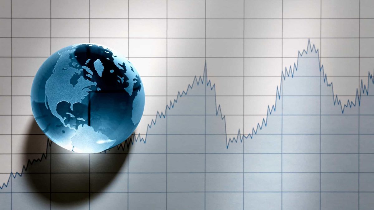 World globe sitting on top of share price chart