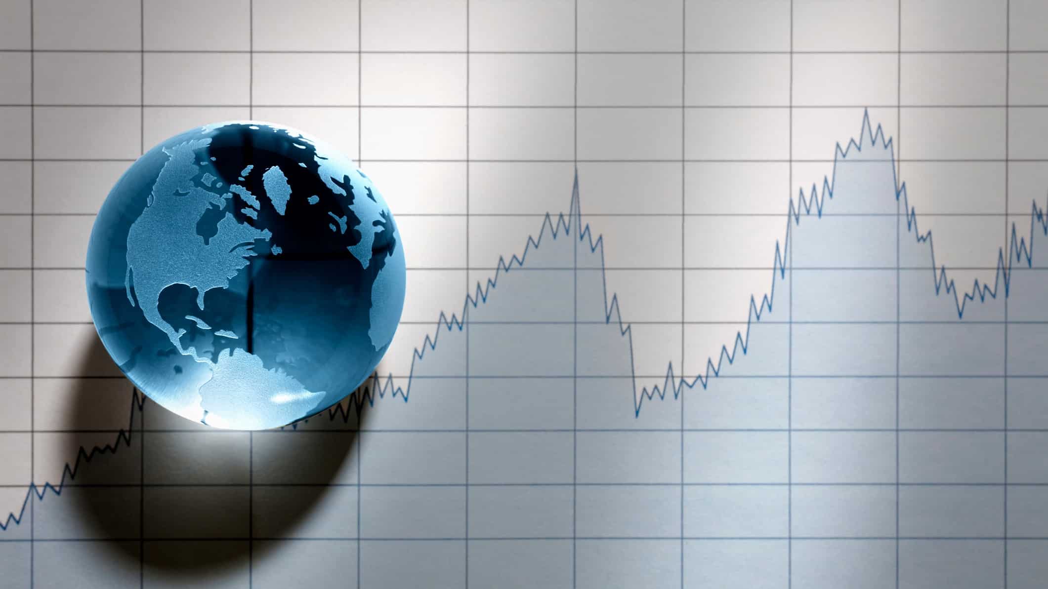 World globe sitting on top of share price chart
