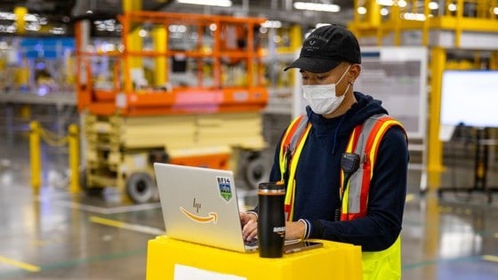 amazon stock represented by amazon worker working in distribution centre