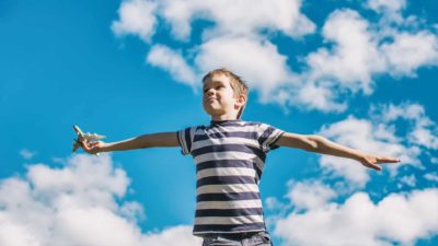 rising airline asx share price represented by boy playing with toy plane