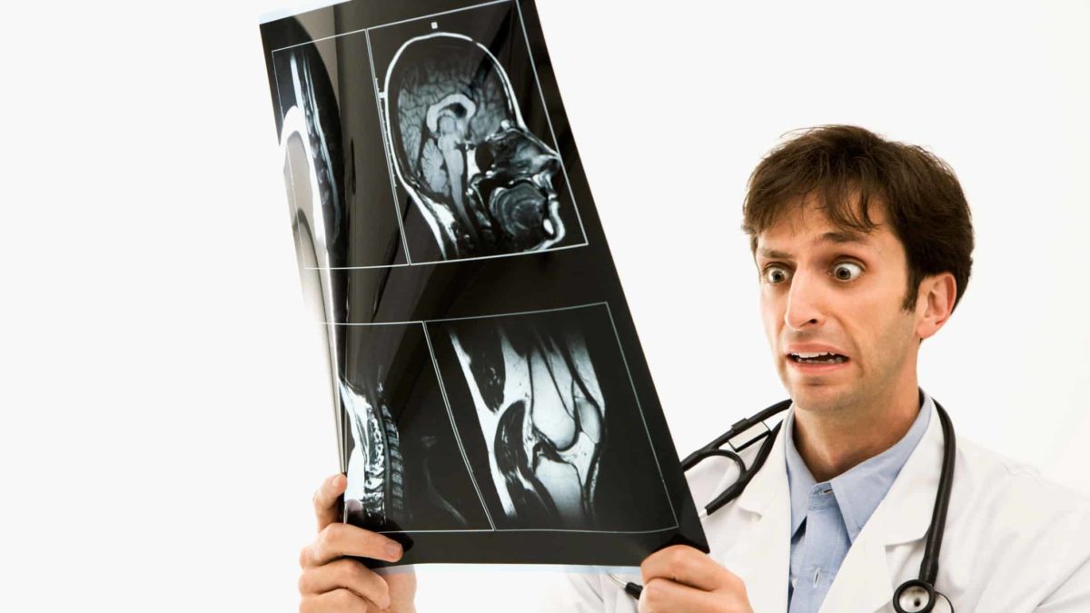 falling healthcare asx share price represented by doctor grimacing at x-ray