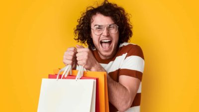 rising retail asx share price represented by excited shopper holding lots of bags best buy