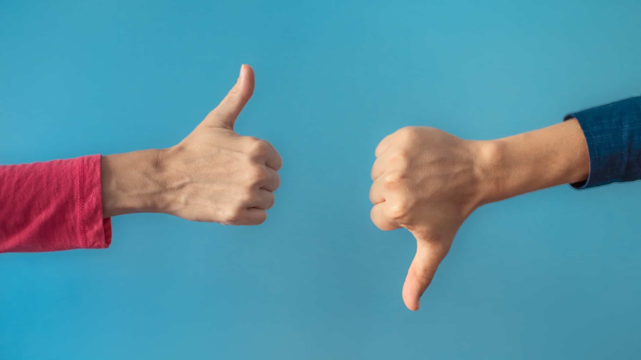 mixed opinions on asx share price represented by two hands, one with thumb up and the other with thumb down.