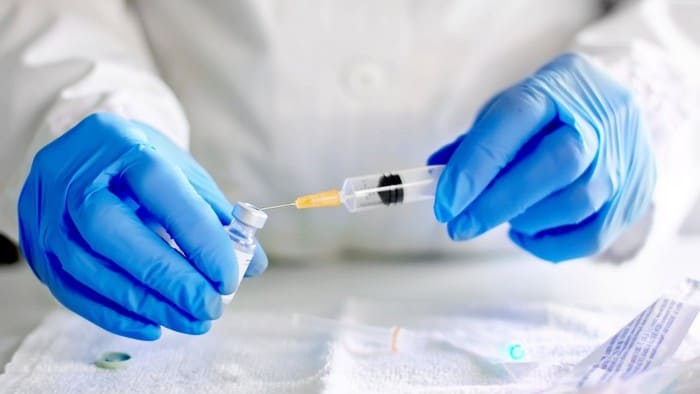 A health worker drug testing in a lab to find 'covid-19 vaccine' representing covid shares