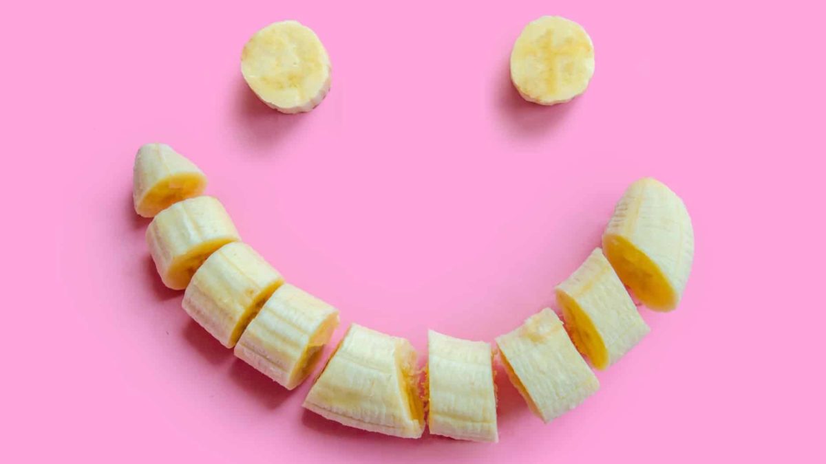 rising asx share price in food and consumer staples sector represented by happy face made from cut up banana