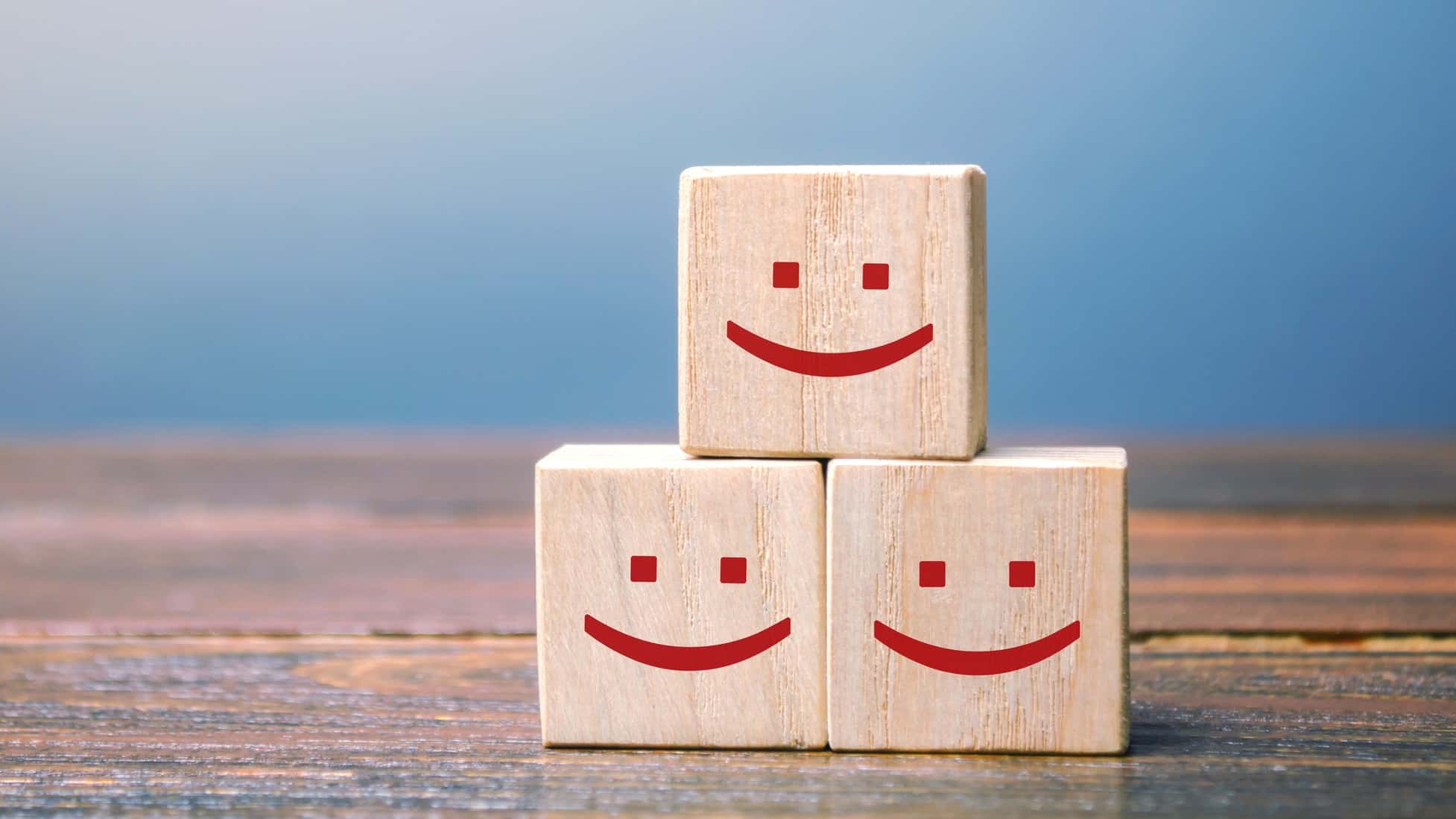 three building blocks with smiley faces, indicating a rise in the ASX share price