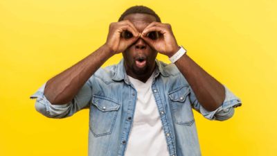 ASX share price on watch represented by surprised man with binoculars