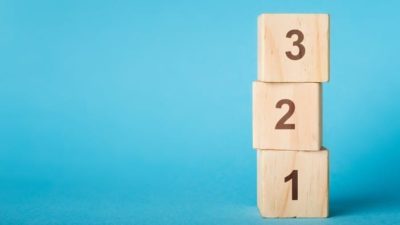 stack of wooden blocks with '1, 2, 3' written on them