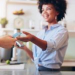 Female cafe employee accepting a card as payment