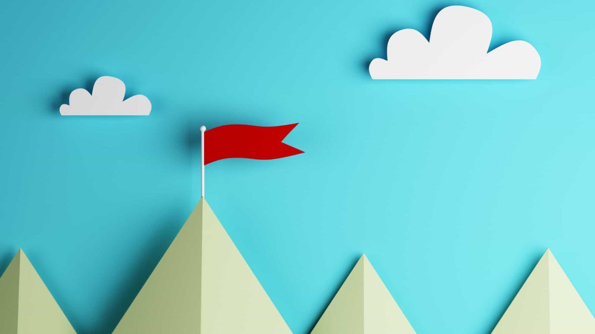 Top asx share price represented by paper cutout image of mountain peaks with red flag