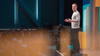 Facebook stock represented by facebook founder Mark Zuckerberg giving speech on stage
