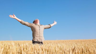 Graincorp share price farming asx share price rise represented by rejoicing farmer in field