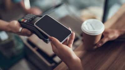 fintech asx share price represented by person using smart phone to pay at checkout