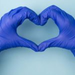 two hands wearing medical gloves make the shape of a heart, indicating the best healthcare shares on the ASX market