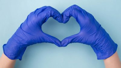 two hands wearing medical gloves make the shape of a heart, indicating the best healthcare shares on the ASX market