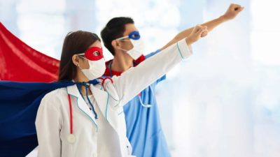 Medical staff wear hero capes, indicting strong shar [price performace for healthcare shares