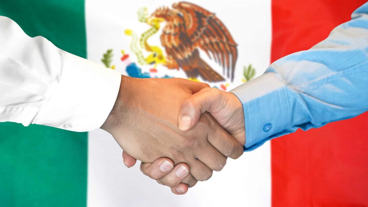 increasing asx share price represented by two hands shaking in front of mexican flag