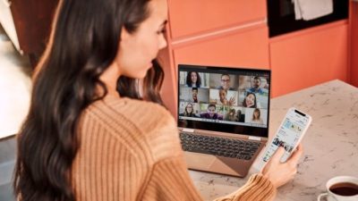 woman sitting at computer using Microsoft teams