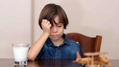 milk asx share price falling represented by sad child with glass of milk