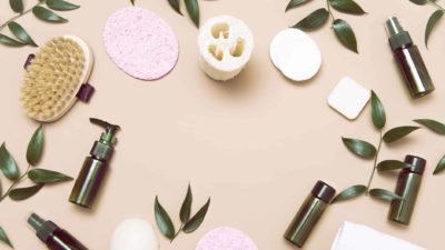 natural skin care asx share price represented by cosmetic bottles, leaves and sponges