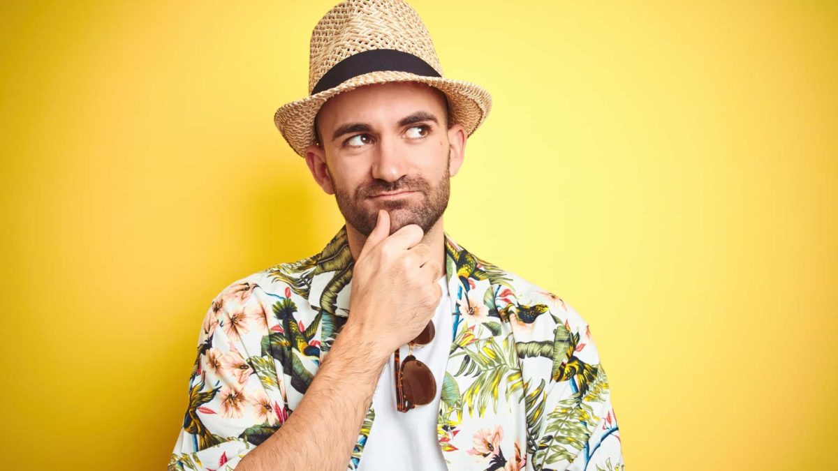 A traveller dressed in colourful shirt and panama hat looking puzzled, indicating uncertainty regarding the Webjet share price