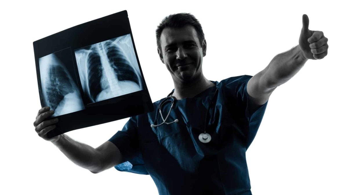 A medical specialist holding a chest an xray or scan and giving a thumbs up, indicating good results for asx healthcare share price