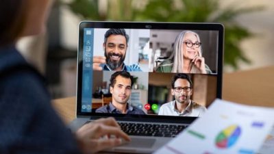 Person engaged in a zoom meeting on laptop computer