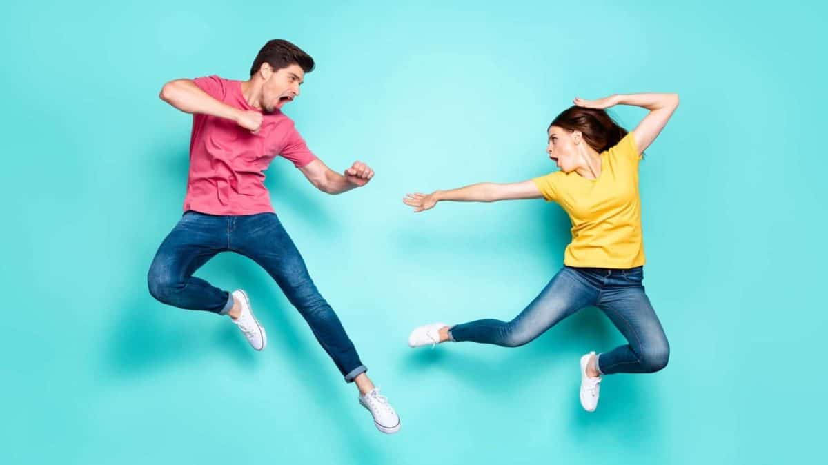 Two people jump in the air in a fighting stance, indicating a battle between rival ASX shares