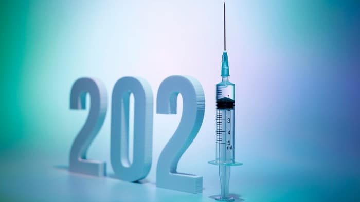 covid vaccine shares represented by numbers 2021 with the one displayed as syringe