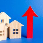 growth in housing asx shares represented by little wooden houses next to rising red arrow