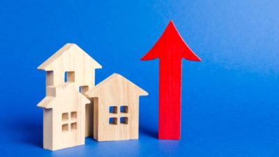 growth in housing asx shares represented by little wooden houses next to rising red arrow