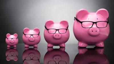 A row a pink piggy banks ranging in size from small to big, indicating ASX share price and dividends growth CBA bank dividend increase