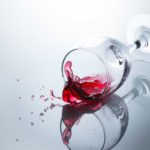 Spilled wine from a glass on the floor.