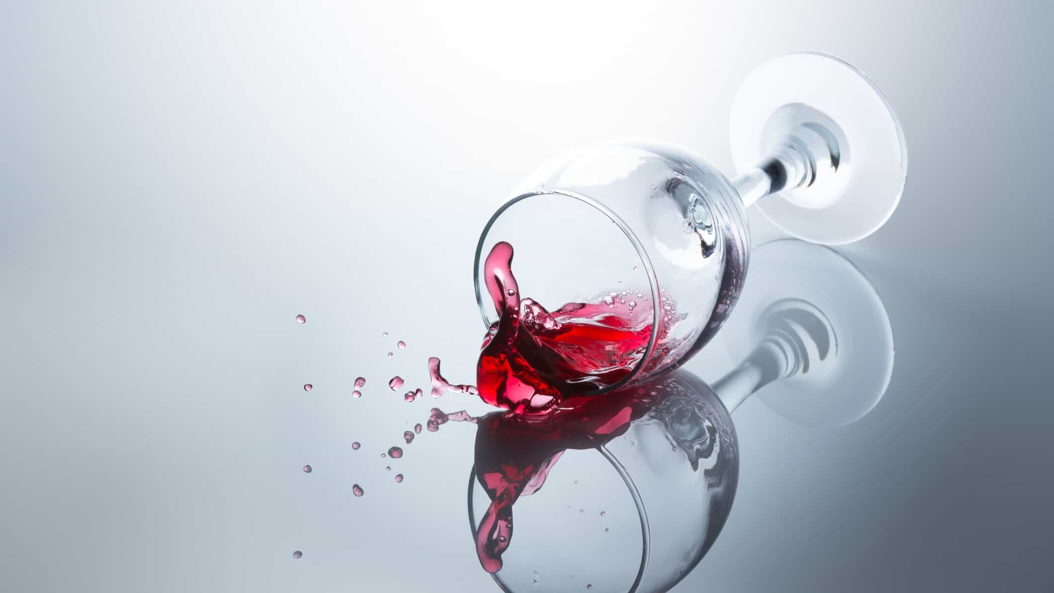 Spilled wine and a glass on its side, indicating a share price drop for ASX wine companies