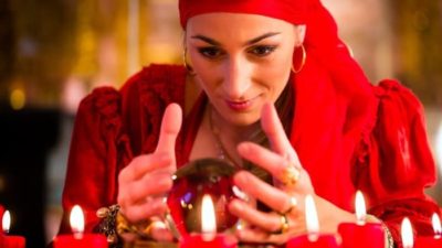 Future ASX share price represented by lady in red scarf stares into crystal ball
