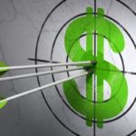 Green tipped arrows in bullseye with green dollar sign