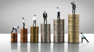 Stacks of coins in a row with each higher than the last, and a person standing on top of each one watching them grow.