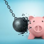 ASX share price crash represented by iron ball smashing into piggy bank.
